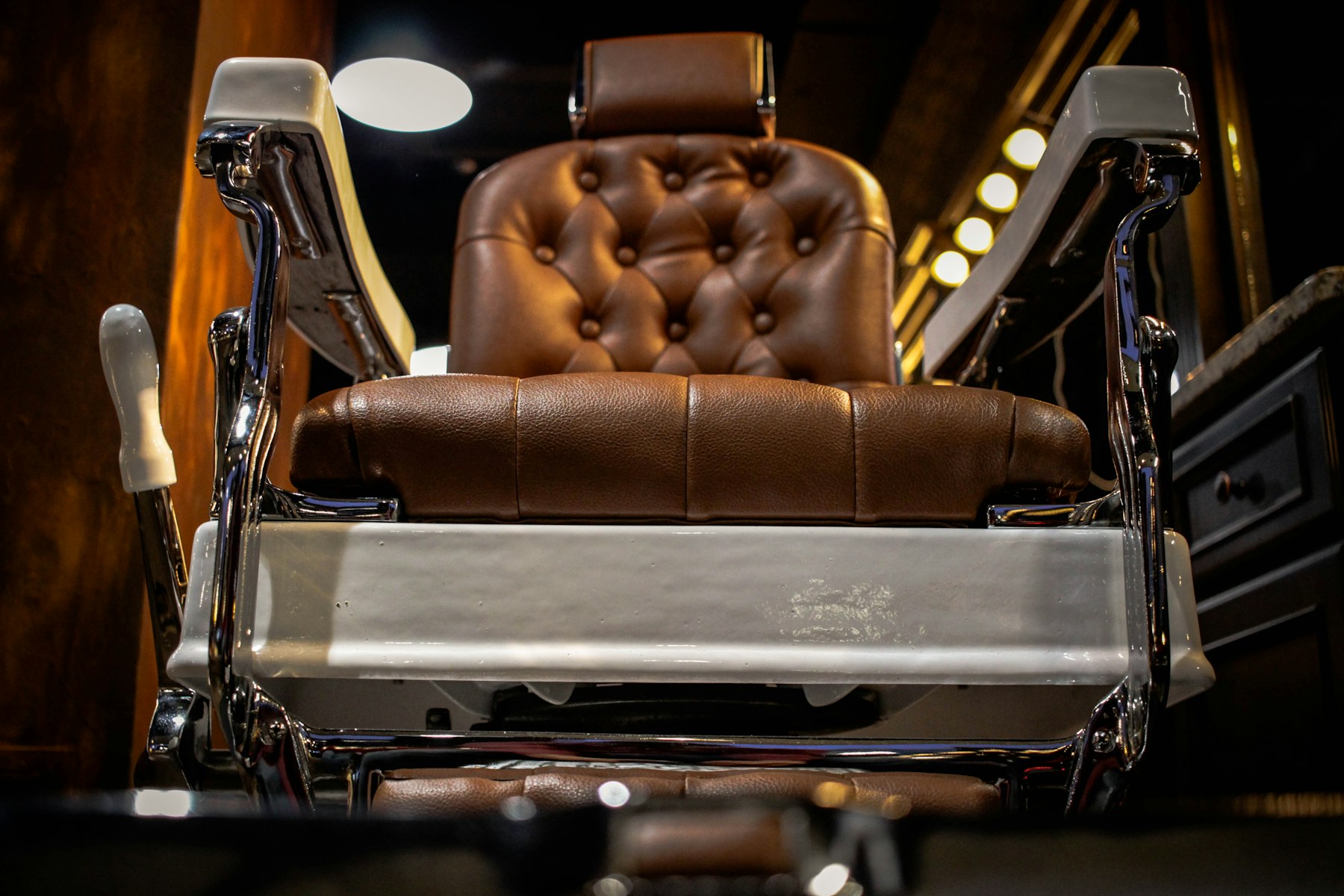 A leather barber chair in a warmly lit shop